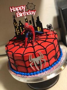 a spiderman birthday cake on top of a table