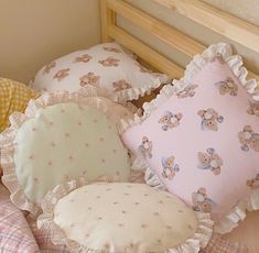 four teddy bears are sitting on pillows in a bed