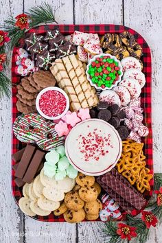 a platter filled with christmas cookies, crackers, and other holiday food items