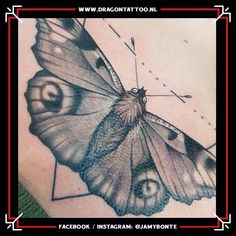 a close up of a butterfly on the back of a woman's shoulder and chest