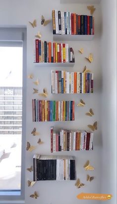 the bookshelf is filled with many different types of books and butterflies on it