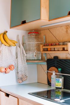 two bananas hanging on the wall in a kitchen