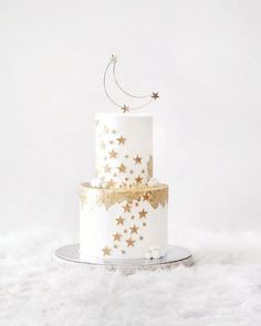 a white and gold cake with stars on it