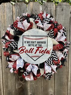 a baseball wreath that says if we don't answer we're at the ball field