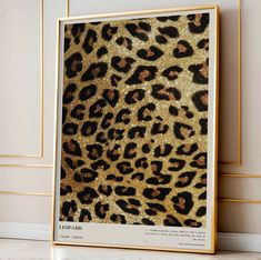 a leopard print with gold glitters on it's back and side, in front of a white wall