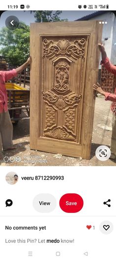 two men standing next to each other in front of a wooden door with carvings on it