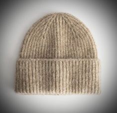 a beige knitted hat on a white background