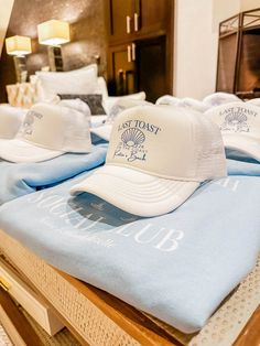 several hats sitting on top of a bed in a room