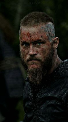 a man with a beard covered in mud