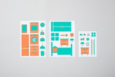 three pieces of paper with different colored designs on them, one in orange and the other in teal