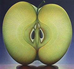 an apple with two halves cut in half on a reflective surface, with one eye open