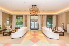 a living room filled with furniture and a chandelier