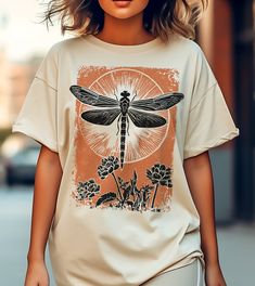 Dragonfly Vintage Shirt, Faded Dragonfly, Block print like, Dragonflies Shirt, Boho, Graphic Tee for Women, Vintage Graphic Shirt,Retro tee This classic unisex jersey short sleeve tee fits like a well-loved favorite. Soft cotton and quality print make users fall in love with it over and over again. These t-shirts have-ribbed knit collars to bolster shaping. The shoulders have taping for better fit over time. Dual side seams hold the garment's shape for longer.  .: 100% Airlume combed and ringspun cotton (fiber content may vary for different colors) .: Light fabric  .: Retail fit .: Tear away label .: Runs true to size SIZE  Unisex Style fro S-3XL PROCESSING TIME 1-7 business days (Depends on the Holidays and stock) PRINTING PROCESS Discover the future of eco-friendly printing with us! Our Vintage Butterfly Print T-shirt For Summer, Retro Tee, Tees For Women, Vintage Graphics, Vintage Shirts, Graphic Shirts, Unisex Fashion, Block Print, Ribbed Knit