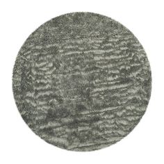 a round rug that is made out of grey fur and has wavy lines on it