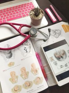 an open book with medical items on it and a laptop computer next to it,