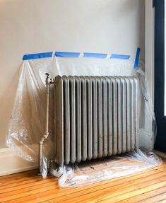 a radiator is wrapped in plastic on the floor