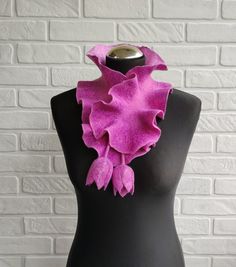 This felted pink scarf with ruffle made from soft merino wool using wet felting techniquein. Felt woolen wavy collar decorated with fiber silk and viscose. The scarf is very lightweight and soft. This is a reversible scarf - a collar that has tulips flower ties. This scarf-wavy collar will complete your look. And also can be a great gift for a woman (wife, mom, sister). The length of the scarf without ties is 25 inches, with ties it is 43 inches. Width - 4.5 - 5 inches Care: Gently hand wash and rinse in no warmer than 90 F water (30-40 C), using a wool/silk detergent. Gently squeeze out excess water (avoid wringing). Iron with steam (using wool temperature settings). More felted scarves  here: https://www.etsy.com/shop/EmbroideredFeltGifts?ref=seller-platform-mcnav%C2%A7ion_id%C2%A7ion_id Pink Scarves For Spring, One Size, Pink One Size Scarf For Spring, Pink One Size Scarves For Spring, Pink One-size Scarves For Spring, Spring Scarves As Gifts, Pink Scarf For Spring Gift, One Size Scarf As Spring Gift, One Size Scarf For Spring Gift, Pink Scarves As Gifts