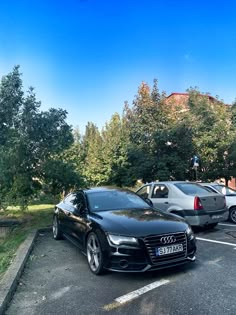 two cars parked in a parking lot next to each other