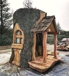 a tree stump house made to look like it is built into the side of a tree