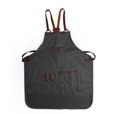 a black apron with brown straps and two pockets on the front, one pocket is open