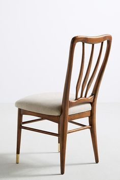 a wooden chair sitting on top of a white floor