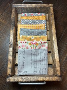 an old wooden crate filled with lots of fabric