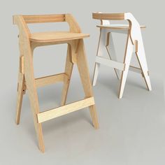 two wooden stools sitting next to each other on a gray surface with one standing up