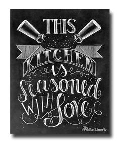 this kitchen is seasoned with love written on a chalkboard wall in black and white