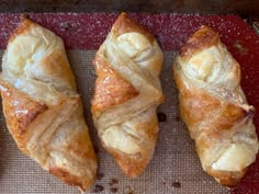 three pastries sitting on top of a red tray