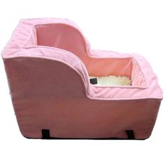 a pink dog bed that is shaped like a car seat with a cat in it