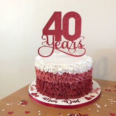 a red and white cake sitting on top of a table