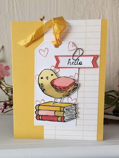 a card with a bird on top of some books