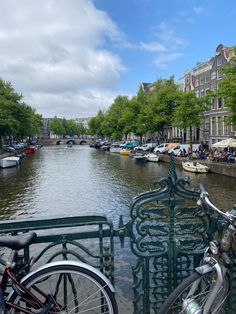 bicycles are parked next to the railings on this canal