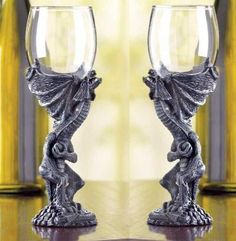 two wine glasses sitting next to each other on a table