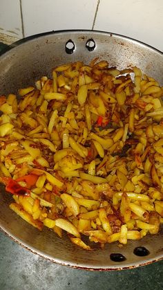 some food is cooking in a pan on the stove top and ready to be cooked