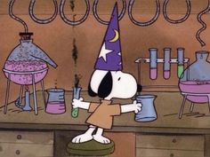 a cartoon dog wearing a party hat and holding a beaker in front of some laboratory equipment