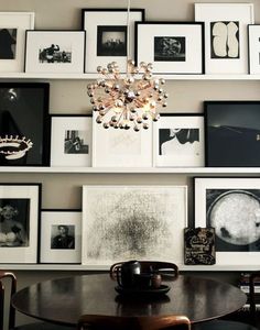 a dining room table and some pictures on the wall