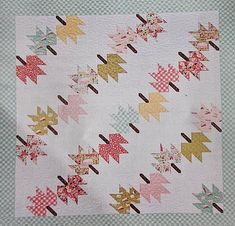 a white quilt with pink and yellow stars on it