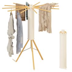 a clothes rack with several pieces of clothing hanging from it's sides and an umbrella stand next to it