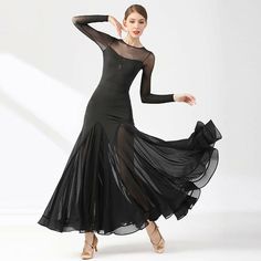 a woman in a black dress is dancing