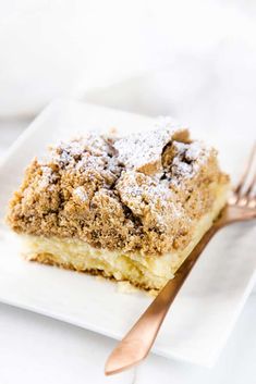 a close up of a piece of cake on a plate with a fork near by