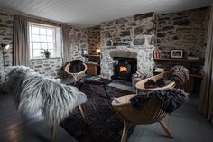 a living room filled with furniture and a fire place in the middle of it's walls