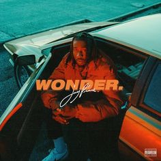 a man sitting inside of a car with the word wonder on it's side