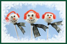 three snowman lollipops with red hats on them