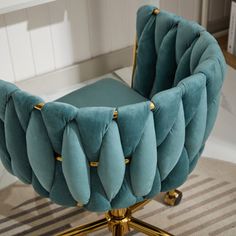 a blue chair sitting on top of a wooden desk