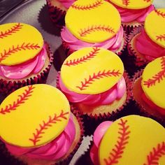 cupcakes decorated with pink and yellow frosting are arranged in a baseball pattern