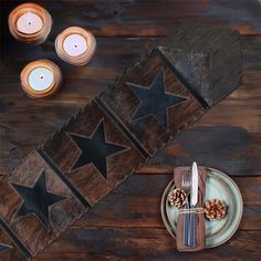 a place setting with candles, plates and napkins