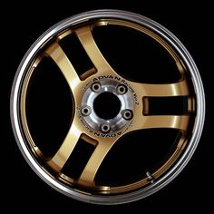 an image of a wheel that is shiny gold and has black lettering on the side