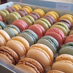 a box filled with lots of different colored macaroons