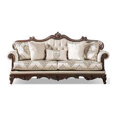 an ornately decorated couch with many pillows on the armrests and back cushions